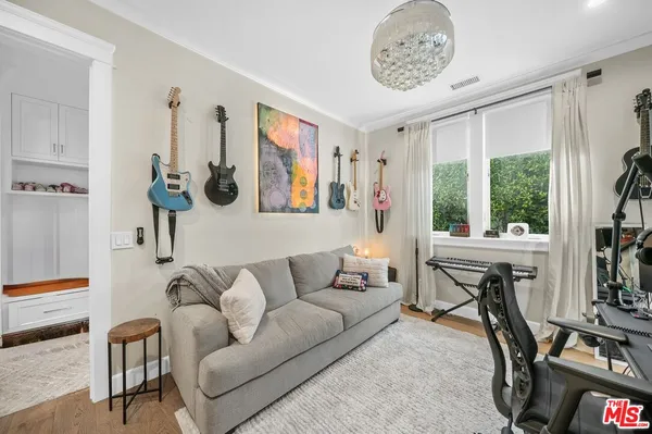 a living room with furniture a window and a flat screen tv