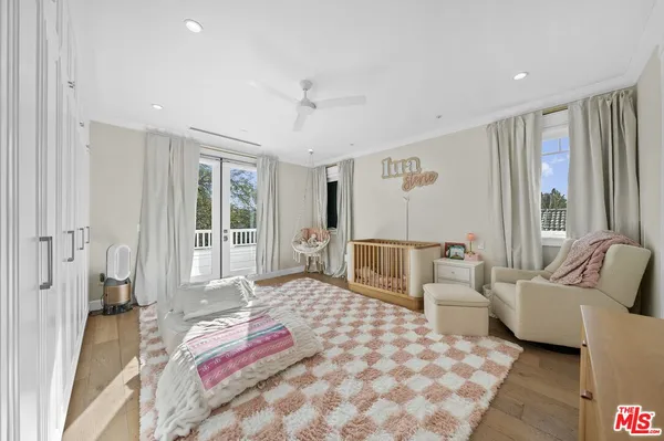 a bedroom with furniture and a large window