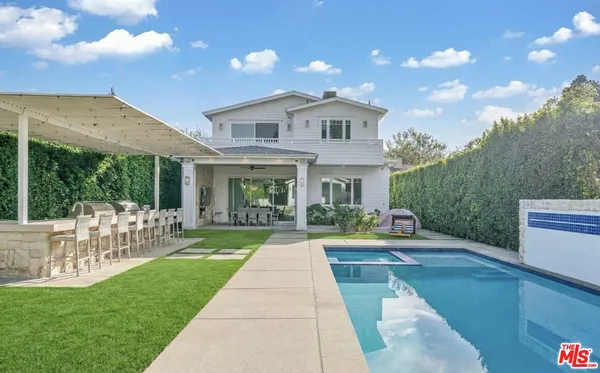 a view of a patio with table and chairs potted plants with wooden fence