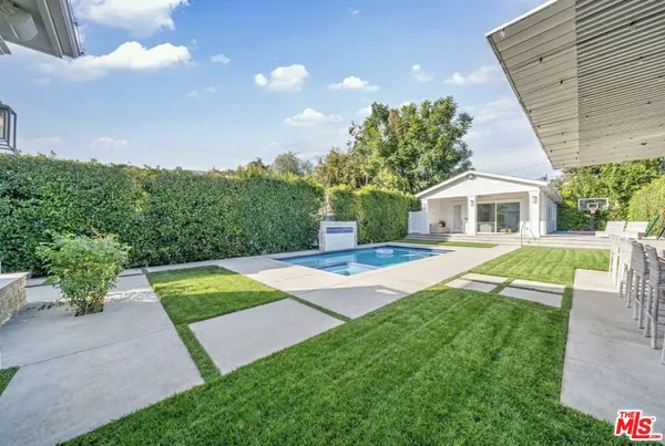 a view of house with swimming pool outdoor seating
