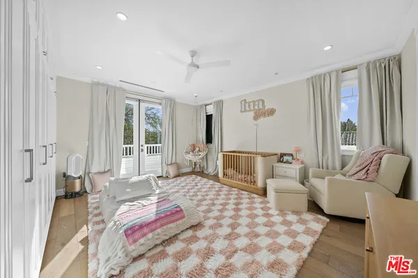a bedroom with furniture and a large window