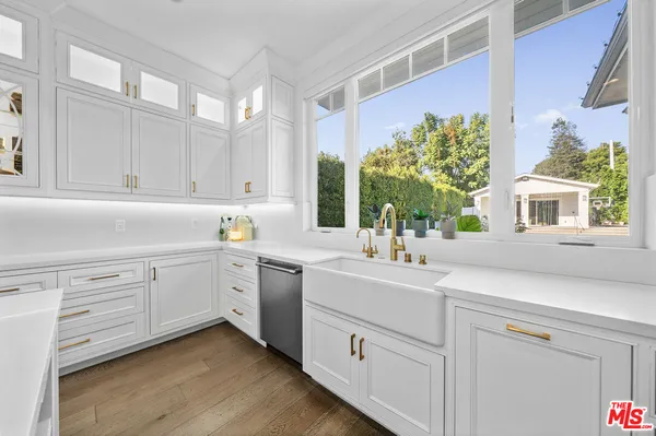 a kitchen with a sink cabinets and window