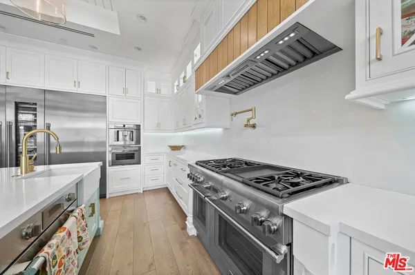 a kitchen with granite countertop a stove and a sink