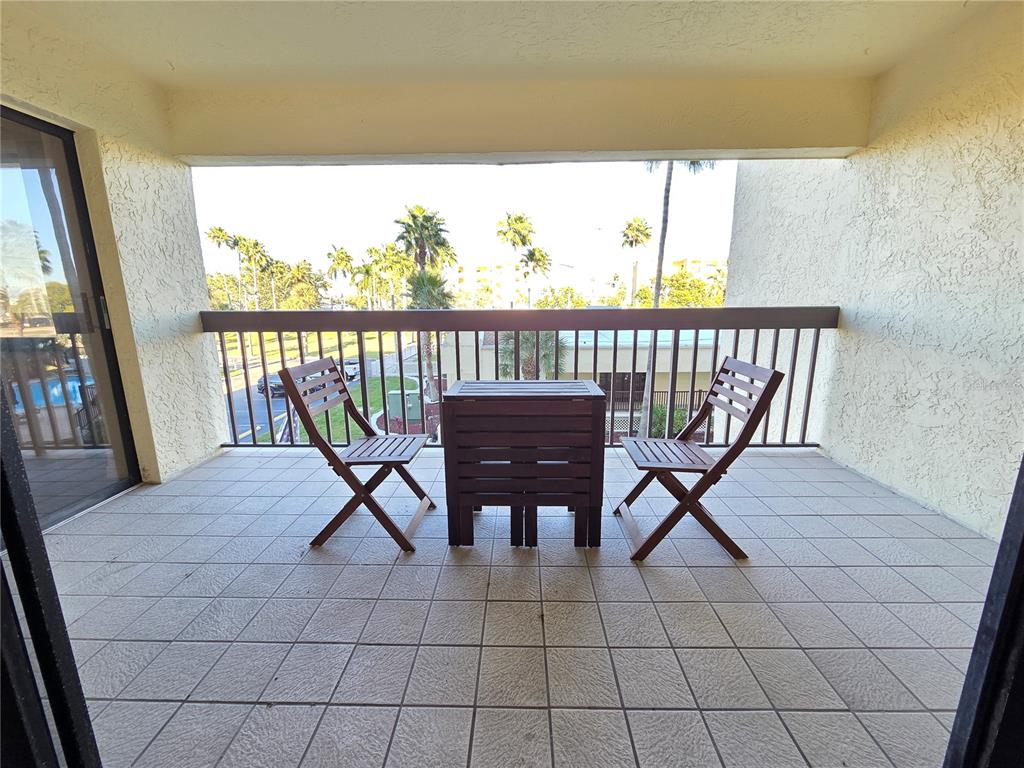 401 150th Avenue, Unit 223 Madeira Beach, FL 33708 - Photo 12 of 50 a view of a chairs and table in the balcony