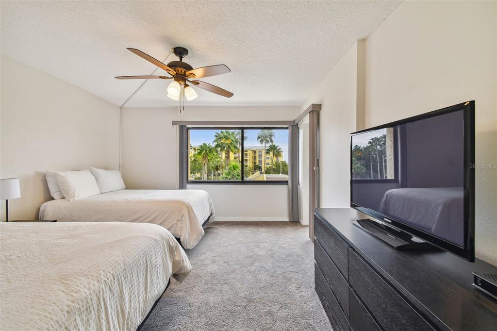 401 150th Avenue, Unit 223 Madeira Beach, FL 33708 - Photo 22 of 50 a bed room with a bed and a window