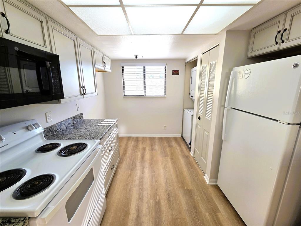 401 150th Avenue, Unit 223 Madeira Beach, FL 33708 - Photo 4 of 50 a kitchen with a sink a refrigerator and a stove