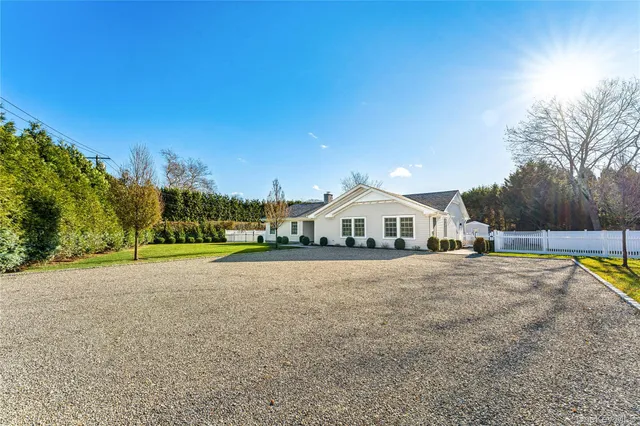 a view of a large house with a big yard and large trees