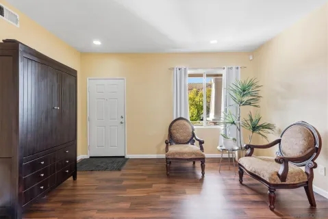 a living room with furniture and wooden floor