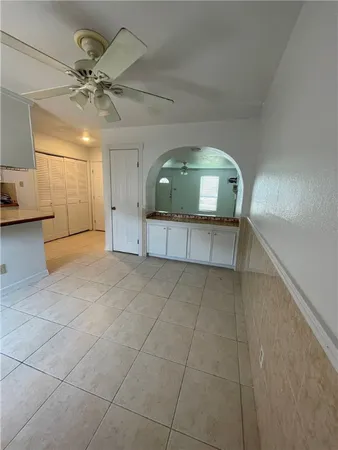 a view of a livingroom with a ceiling fan and window