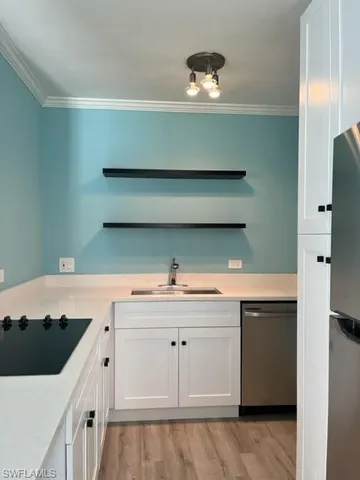 a kitchen with cabinets and stainless steel appliances