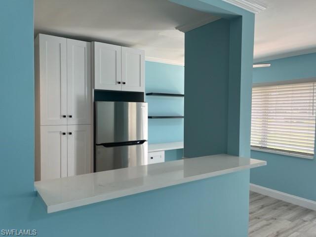 473 12th Avenue South, Unit B2 Naples, FL 34102 - Photo 13 of 23 a kitchen with cabinets and stainless steel appliances