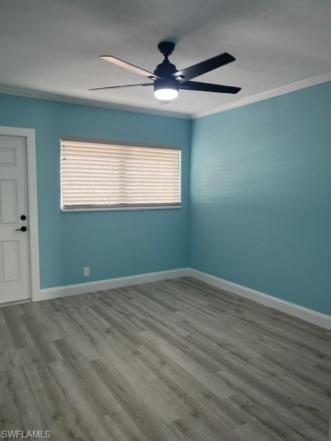 473 12th Avenue South, Unit B2 Naples, FL 34102 - Photo 17 of 23 an empty room with wooden floor chandelier fan and windows
