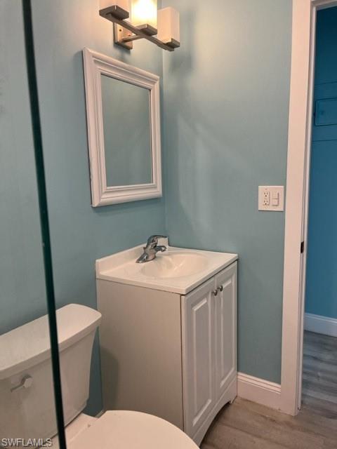 473 12th Avenue South, Unit B2 Naples, FL 34102 - Photo 20 of 23 a bathroom with a sink a toilet and mirror