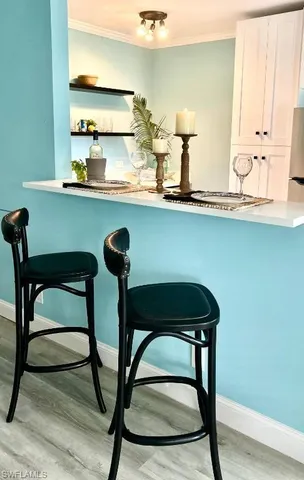 a view of a kitchen with furniture and wooden floor