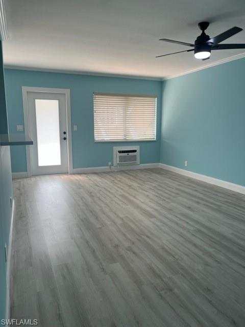 473 12th Avenue South, Unit B2 Naples, FL 34102 - Photo 10 of 23 an empty room with wooden floor and windows