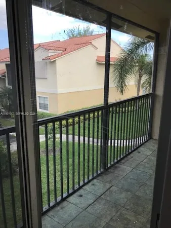 a view of a balcony with a floor to ceiling window window and wooden floor