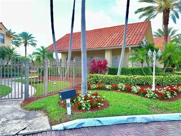 a front view of a house with a garden and plants