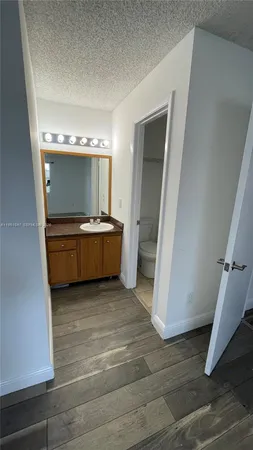 a view of a room with wooden floor and cabinet