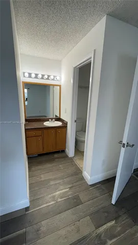 a view of a room with wooden floor and cabinet