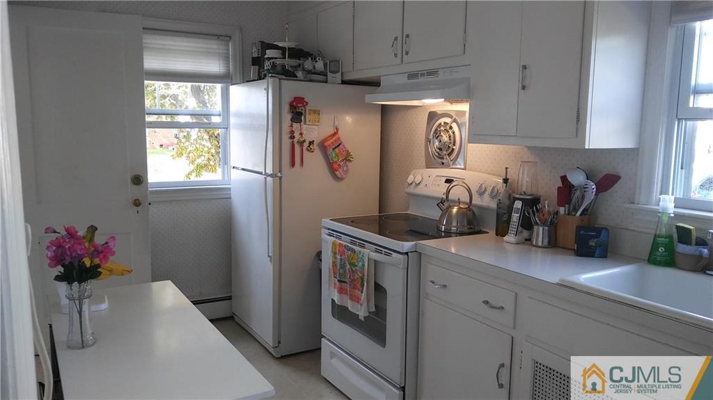 522 Crows Mill Road Fords, NJ 08863 - Photo 11 of 14 a kitchen with stainless steel appliances granite countertop a refrigerator a sink a stove and white cabinets