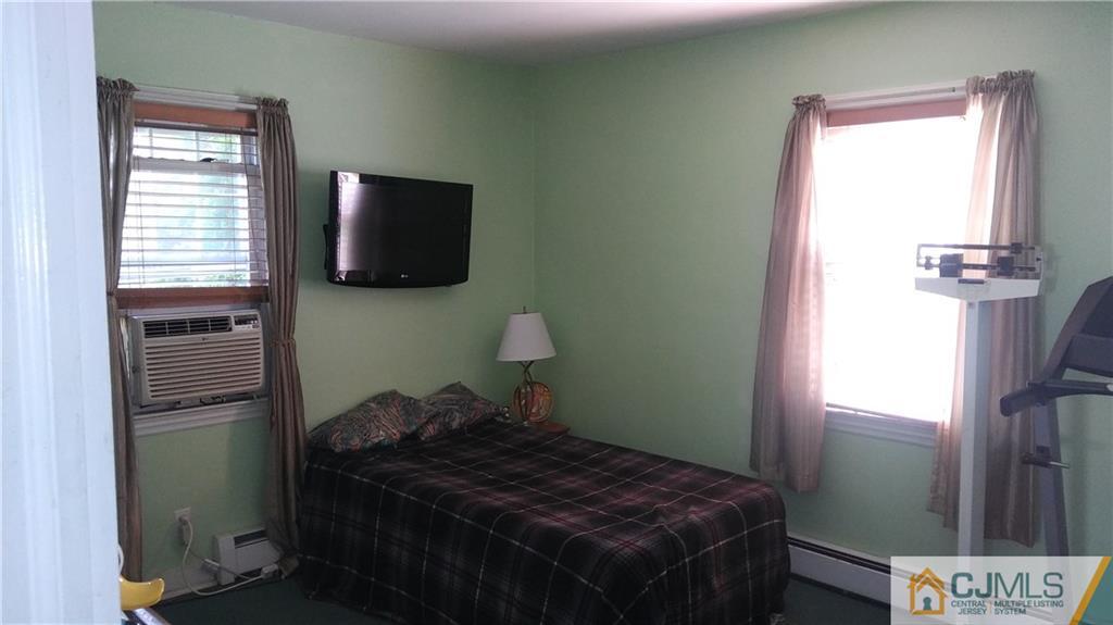 522 Crows Mill Road Fords, NJ 08863 - Photo 5 of 14 a bed sitting in a bedroom next to a window