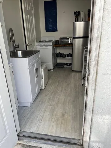 a view of a kitchen with refrigerator and microwave
