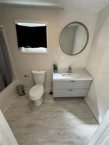a bathroom with a sink mirror and toilet