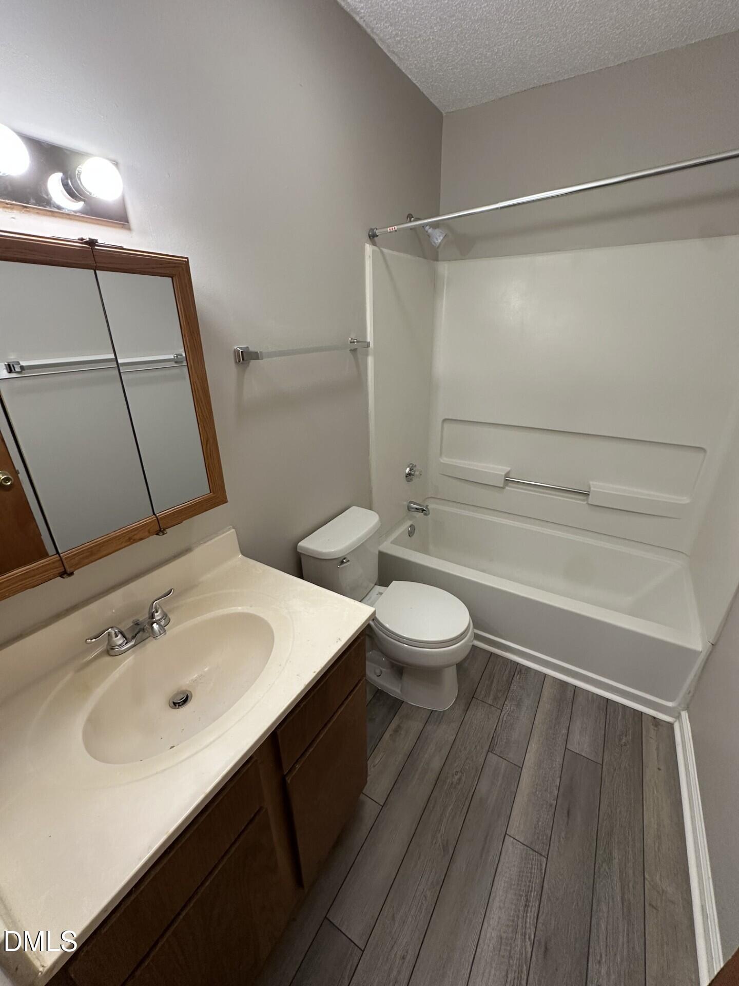 2904 Faversham Place Raleigh, NC 27604 - Photo 8 of 9 a bathroom with a sink a toilet a mirror and shower
