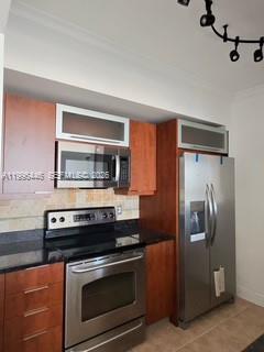 7350 Southwest 89th Street, Unit 1102S Miami, FL 33156 - Photo 12 of 30 a kitchen with stainless steel appliances granite countertop a refrigerator and a stove top oven