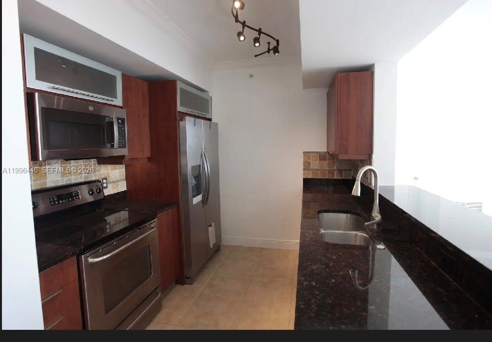7350 Southwest 89th Street, Unit 1102S Miami, FL 33156 - Photo 30 of 30 a kitchen with a sink stainless steel appliances and cabinets