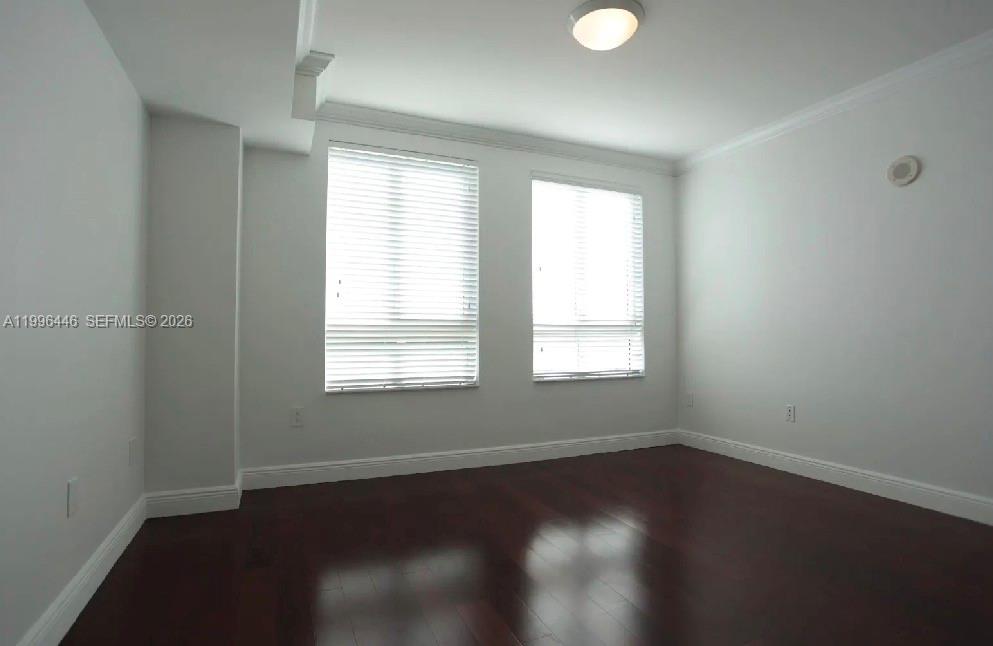 7350 Southwest 89th Street, Unit 1102S Miami, FL 33156 - Photo 7 of 30 an empty room with wooden floor and windows