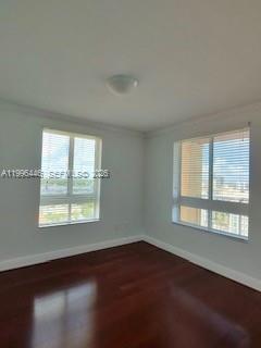 7350 Southwest 89th Street, Unit 1102S Miami, FL 33156 - Photo 10 of 30 an empty room with wooden floor and windows