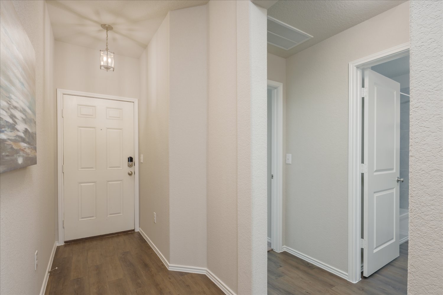 5812 Bell Tower Lane Austin, TX 78747 - Photo 17 of 24 Corridor with dark wood finished floors