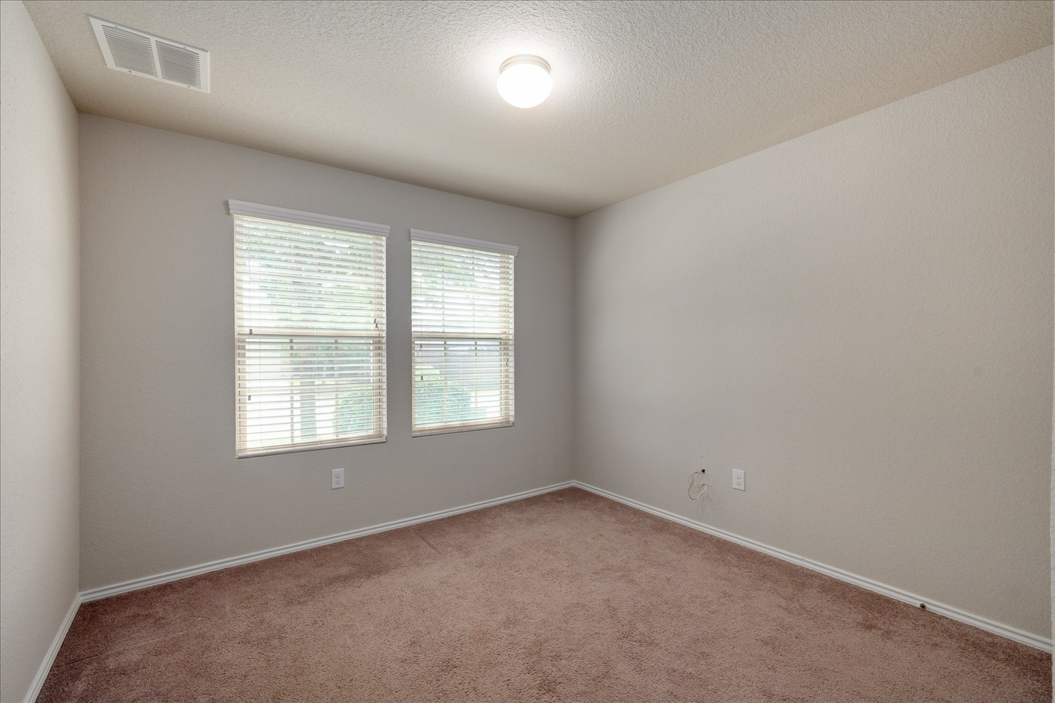 5812 Bell Tower Lane Austin, TX 78747 - Photo 18 of 24 Unfurnished room featuring carpet and a textured ceiling