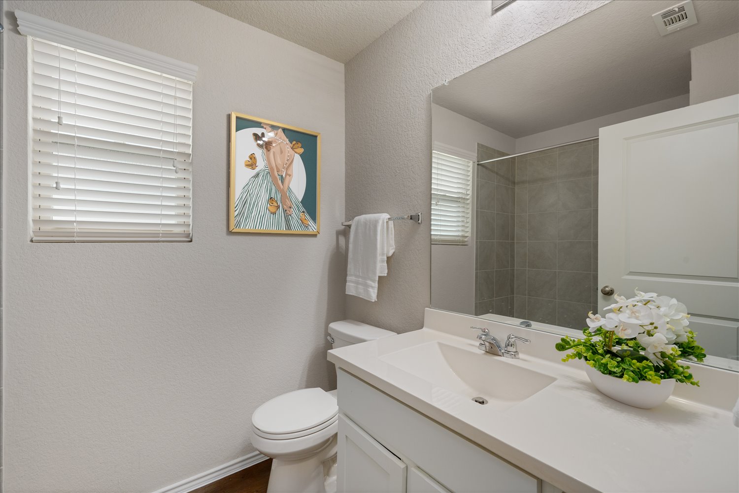 5812 Bell Tower Lane Austin, TX 78747 - Photo 20 of 24 Bathroom with a textured wall, vanity, and a shower