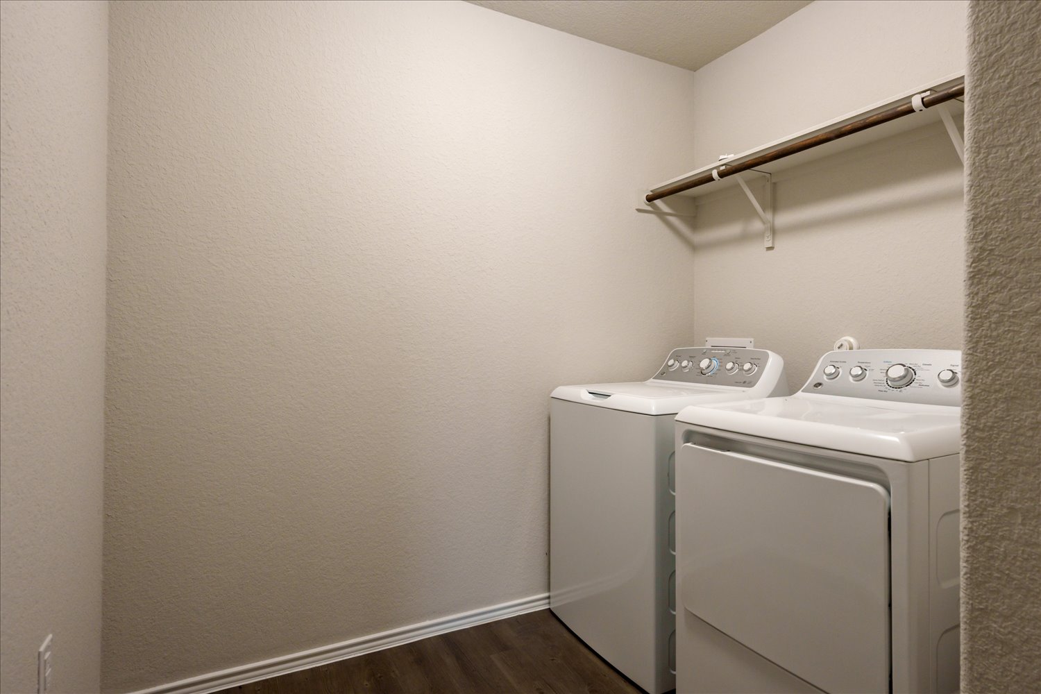 5812 Bell Tower Lane Austin, TX 78747 - Photo 21 of 24 Laundry room with dark wood-style flooring and washing machine and dryer