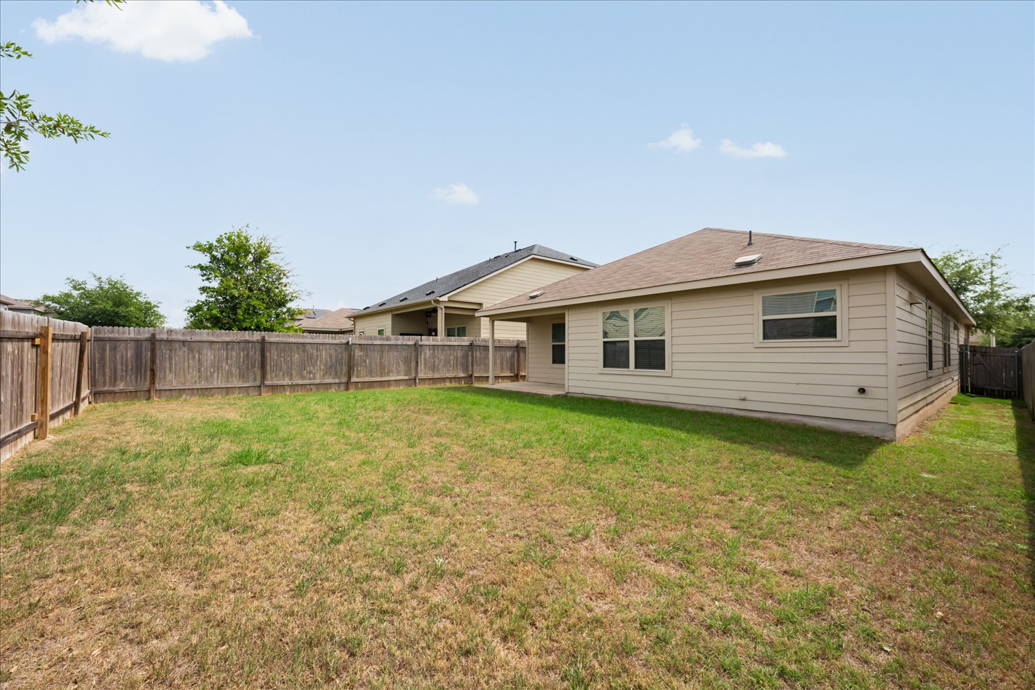 5812 Bell Tower Lane Austin, TX 78747 - Photo 24 of 24 Back of house with a patio area and a fenced backyard
