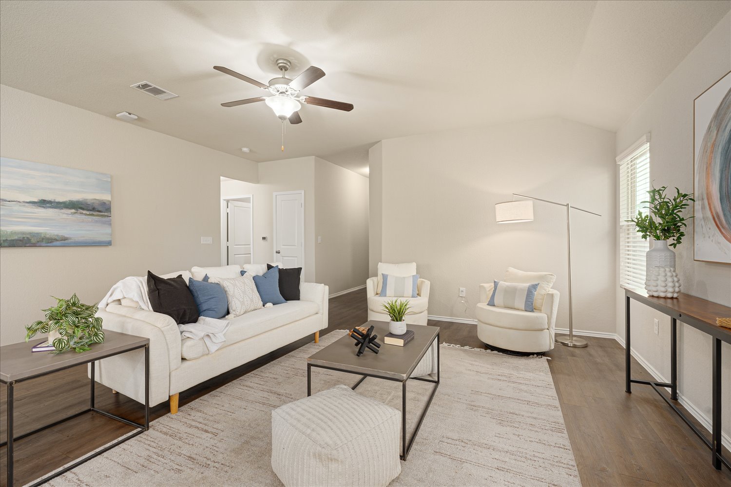 5812 Bell Tower Lane Austin, TX 78747 - Photo 4 of 24 Living room featuring a ceiling fan, wood finished floors, and lofted ceiling