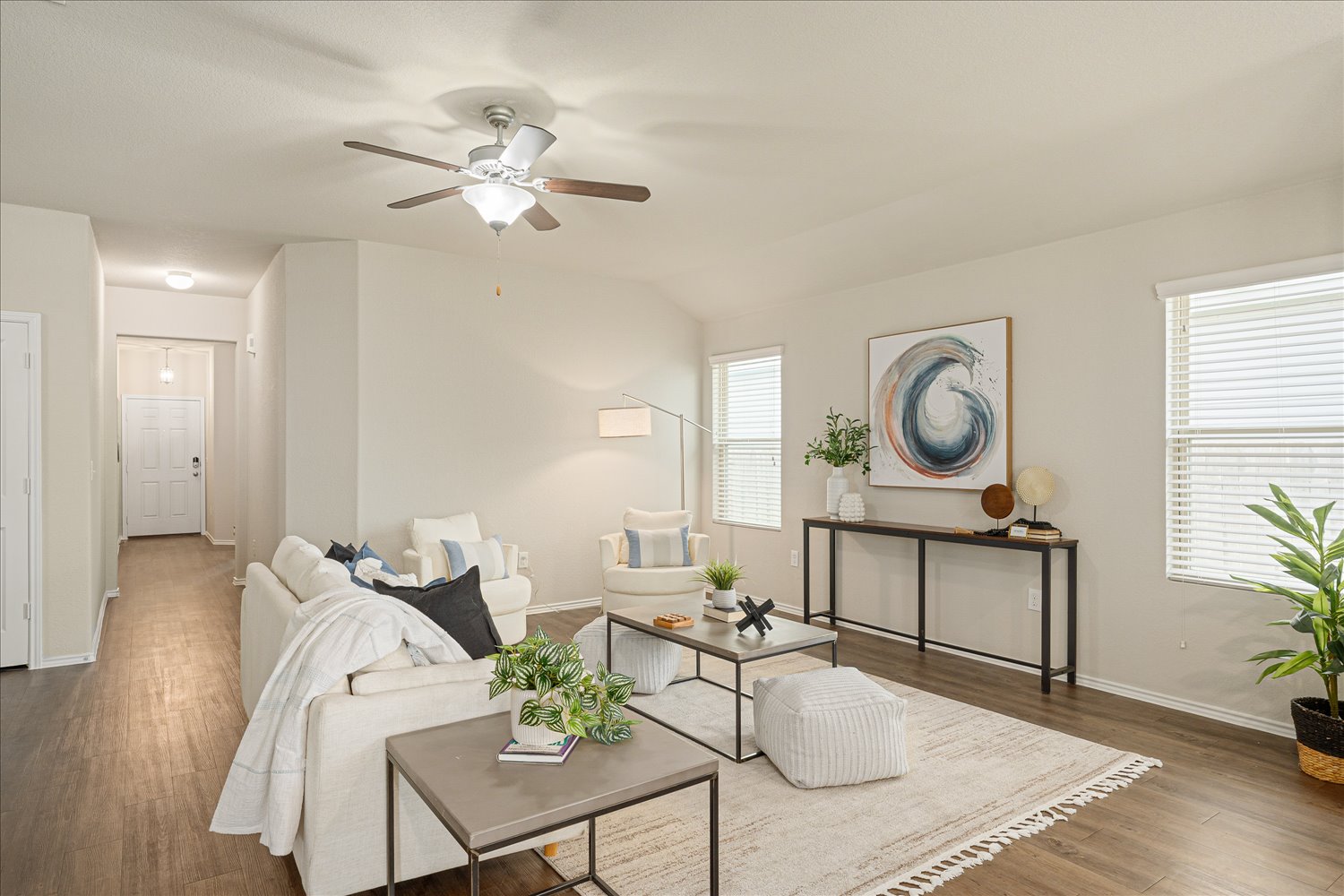 5812 Bell Tower Lane Austin, TX 78747 - Photo 5 of 24 Living room featuring a ceiling fan, wood finished floors, and vaulted ceiling