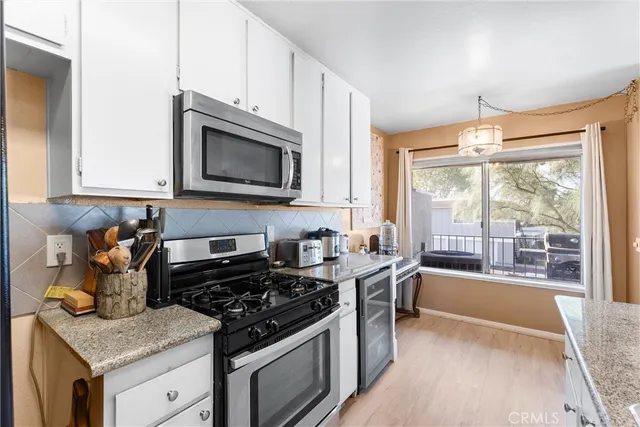 a kitchen with a stove a sink and a microwave