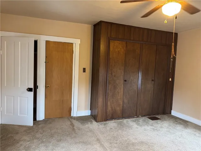 an empty room with closet area
