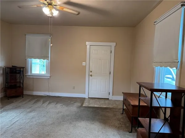 an empty room with windows and cabinet