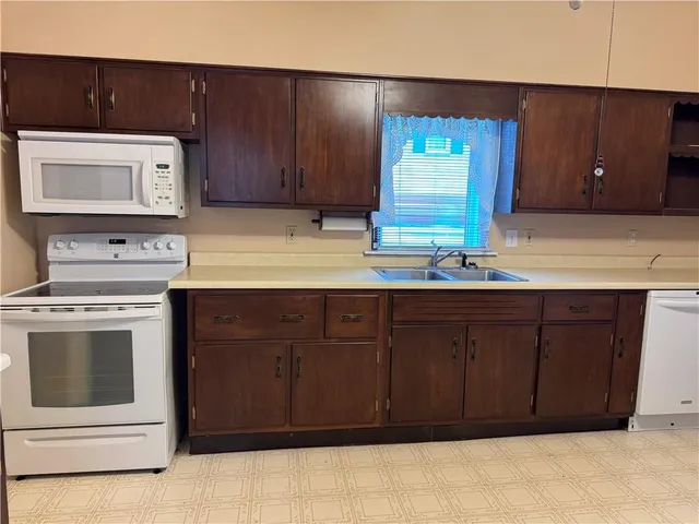 a kitchen with a cabinets and white stove