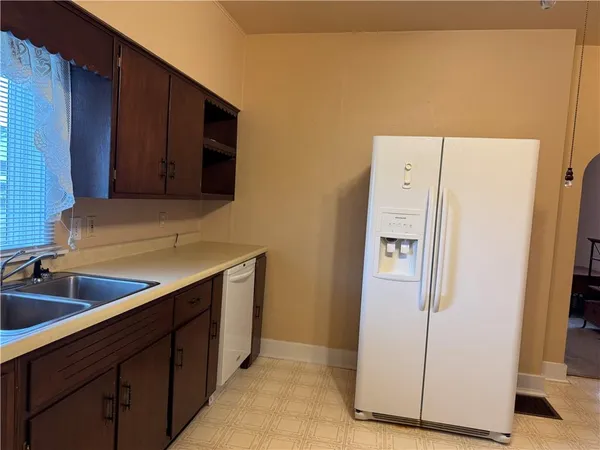 a kitchen with a refrigerator and a sink
