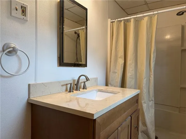 a bathroom with a sink vanity mirror and a sink