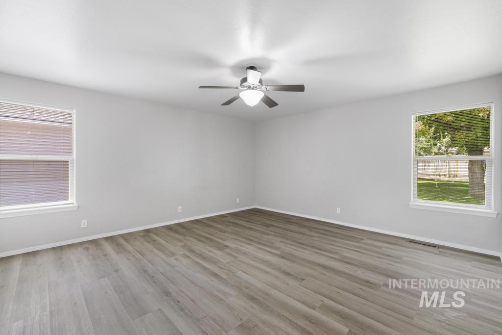 1183 Cortes Loop Twin Falls, ID 83301 - Photo 17 of 30 Spacious room featuring light wood-finish flooring, neutral gray wall paint, and white trim