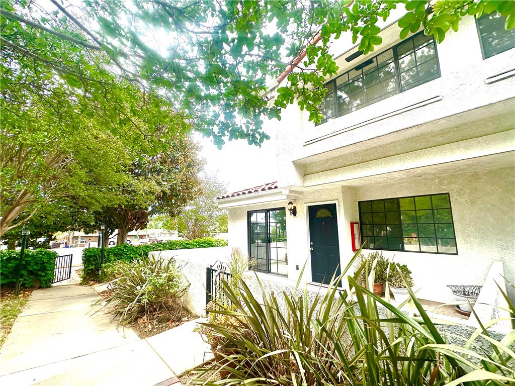 9356 19th Street, Unit A Rancho Cucamonga, CA 91701 - Photo 2 of 23 a view of a house with backyard and trees
