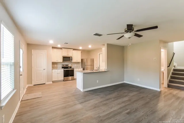 a view of a kitchen with a sink and a stove top oven