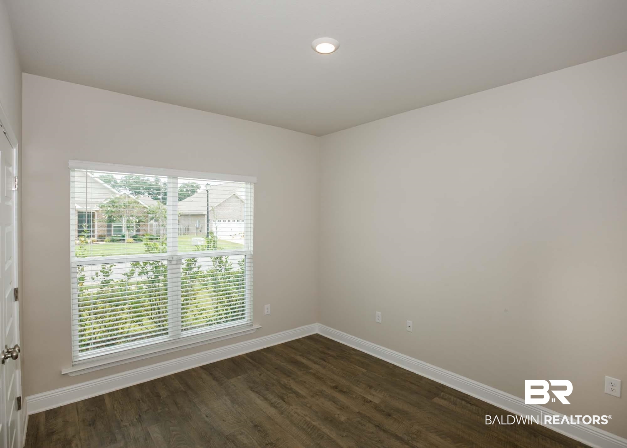 1436 Kairos Loop Foley, AL 36535 - Photo 34 of 52 Spare room with healthy amount of natural light and dark wood-type flooring