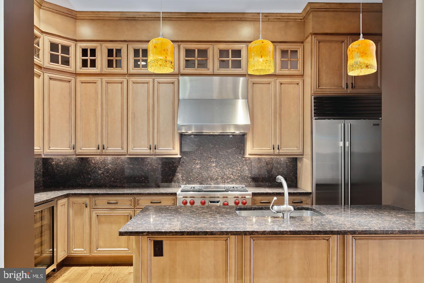 a kitchen with stainless steel appliances granite countertop a sink and cabinets